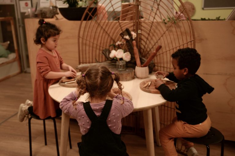 Play Based Learning - image of three children at a table